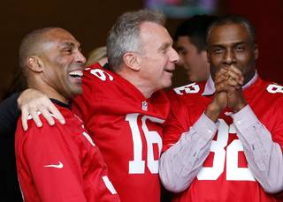 From left, former San Francisco 49ers players Roger Craig, Joe Montana and John Taylor gather before a halftime ceremony during an NFL football game between the 49ers and the Cincinnati Bengals in Santa Clara, Calif., Sunday, Dec. 20, 2015.