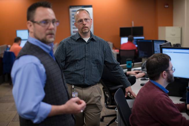 Sean Parcel, AEP’s lead cyberinvestigator, center, stands with Steve Swick, senior manager of cyber intelligence and defense, left, Wednesday, May 20, 2015, in the Cyber Security Operations Center at AEP headquarters in Columbus, Ohio. Parcel says, "If the motivation is high enough on the attacker side, and they have funding to accomplish their mission, they will find a way."