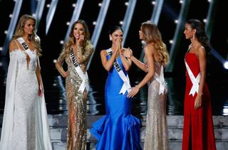 The final five contestants, including Miss Philippines Pia Alonzo Wurtzbach, center, react onstage at the 2015 Miss Universe Pageant on Sunday, Dec. 20, 2015, at Planet Hollywood.