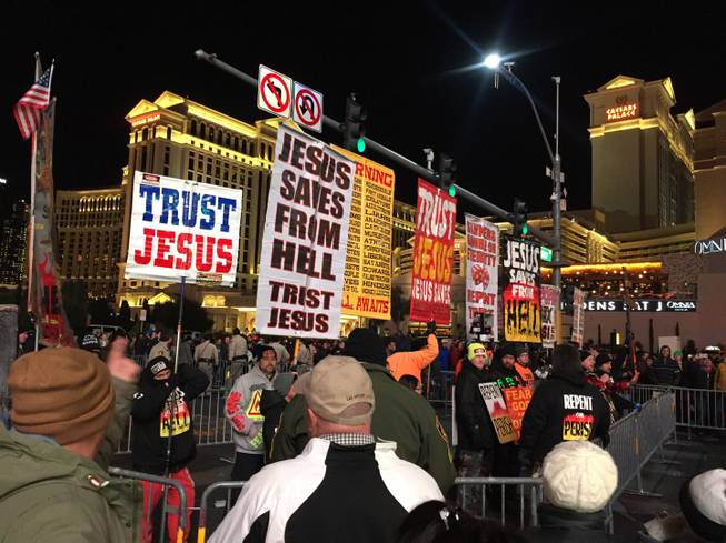 A religious group is shown in a barricaded area near Caesars Palace, Thursday, Dec. 31, 2015.