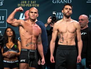 Welterweight Champion Robbie Lawler and challenger Carlos Condit pose before the crowd during the UFC 195 weigh ins at the MGM Grand Garden Arena on Friday, January 1, 2016.