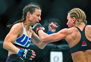 Women's Strawweight Nina Ansaroff takes a shot to the chin from Justine Kish during their UFC 195 fight at the MGM Grand Garden Arena on Saturday, January 2, 2016.