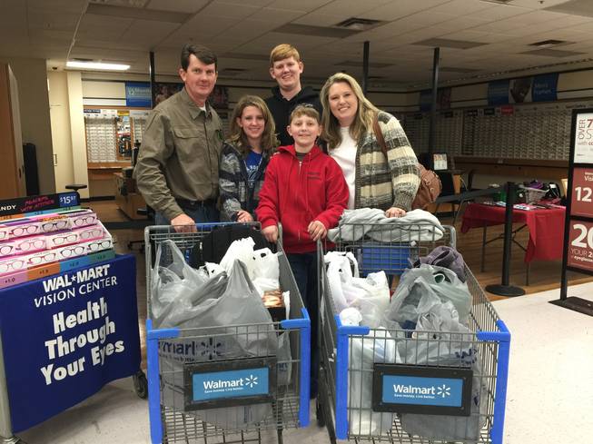From left, John, Sarah, Nathan, Michael and Sanna Cain are pictured after members of Operation FireH.E.A.T. took them shopping for basic necessities. The Cains' home was destroyed in a fire Dec. 28, 2015, and the nonprofit organization bought them toiletries, clothing and school supplies as well as providing Christmas gifts.