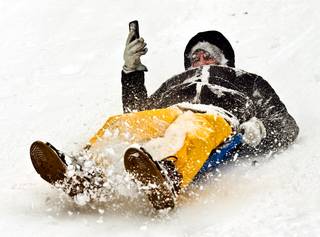 Tommy Fisher shoots video of himself as he sleds with friends about Trail Canyon while a winter storm rolls through the region and dumps more snow on Mt. Charleston on Tuesday, January 5, 2016.