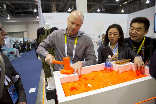 Mike Fulmer, of D30 Impact Protection, demonstrates the protective power of his producy by attempting to smash his fingers with a hammer. This plyable gel quickly turns into a solid upon impact. CES Wed, Jan. 6, 2016.