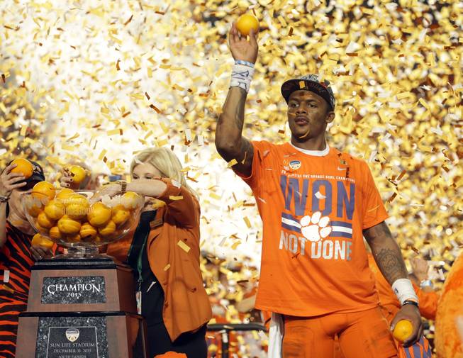 Clemson quarterback Deshaun Watson (4) throws oranges to the crowd after his team won the Orange Bowl NCAA college football semifinal playoff game against Oklahoma, Thursday, Dec. 31, 2015, in Miami Gardens, Fla. Clemson defeated Oklahoma 37-17.