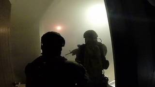 This frame-grab taken from Jan. 8, 2016 video released by Mexico's presidential press office, shows Mexican navy marines storming a home during the operation to recapture Mexico's most wanted drug kingpin, Joaquin 
