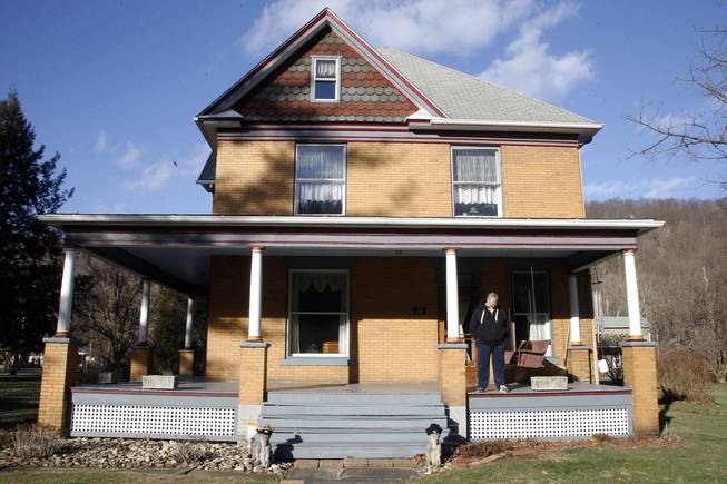 Scott Lloyd stands on the front porch of his home, which is the house used as the home of killer Buffalo Bill in the 1991 film “The Silence of the Lambs,” on Monday, Jan. 11, 2016, in Perryopolis, Pa.