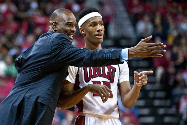 UNLV assistant coach Stacey Augmon confers play with UNLV guard Patrick McCaw (22) during a foul shot over New Mexico at the Thomas & Mack Center on Tuesday, January 12, 2016.