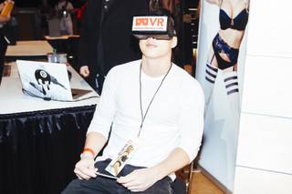 An attendee demonstrates a virtual-reality headset from VRSexperience during the 2016 AVN/Adult Entertainment Expo on Wednesday, Jan. 20, 2016, at the Hard Rock Hotel.