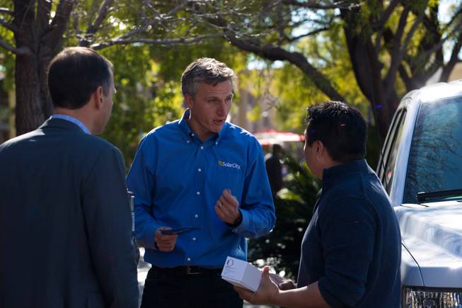 From left: Marco Krapels, Senior VP of Strategy SolarCity, and SolarCity CEO, Lyndon Rive, speak to Vegas local Michael Teanio regarding support of a new bill that will restore prior rooftop solar rates, Monday Jan. 25, 2016.