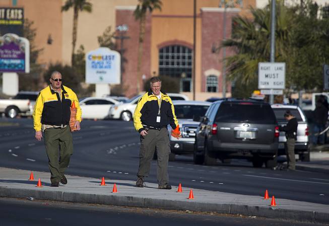 Metro Police accident investigators place evidence cones at the scene of auto-pedestrian accident at a bus shelter on Lake Mead Boulevard near Rancho Drive Thursday, Feb. 4, 2016.