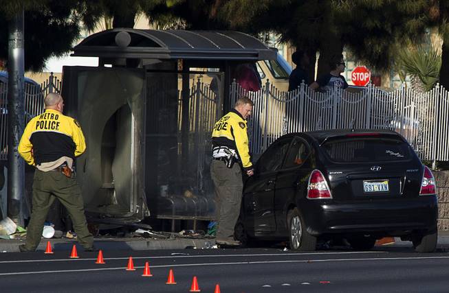 Metro Police accident investigators look over the scene of auto-pedestrian accident at a bus shelter on Lake Mead Boulevard near Rancho Drive Thursday, Feb. 4, 2016.