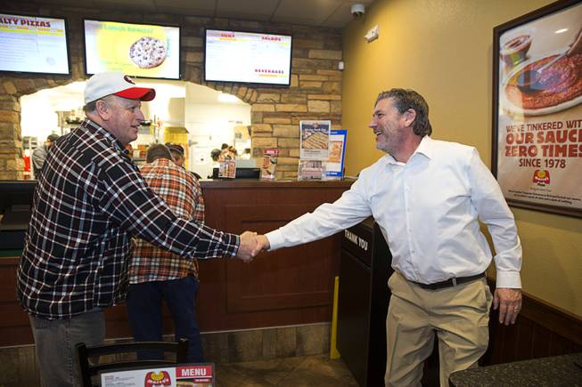Customer Jim Rengel, left, shakes hands with Bryon Stephens, president and COO of Marco's Pizza, after recognizing him in the Marco's Pizza at 3400 S. Hualapai Way Thursday, Feb. 4, 2016. Stephens recently appeared on the CBS show "Undercover Boss."  The franchise has nearly 700 locations in 35 states and plans to open 8 more restaurants in the Las Vegas Valley, Stephens said.