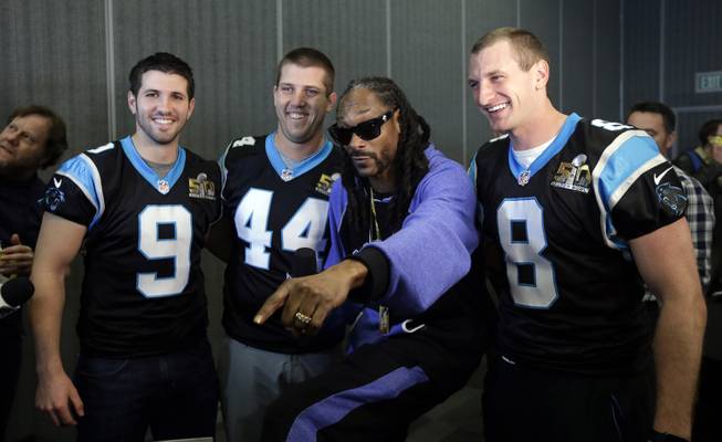 Recording artist Snoop Dogg, second from right, poses for pictures with Carolina Panthers' Graham Gano (9), J.J. Jansen (44) and Brad Nortman (8) during a press conference in preparation for the Super Bowl 50 football game Thursday Feb. 4, 2016 in San Jose, Calif. 