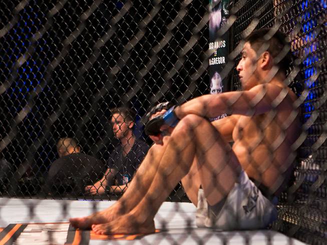 Featherweight Diego Rivas sits in the octagon looking at downed opponent  Noad Lahat following their UFC Fight Night 82 match at the MGM Grand Garden Arena on Saturday, February 6 2016.
