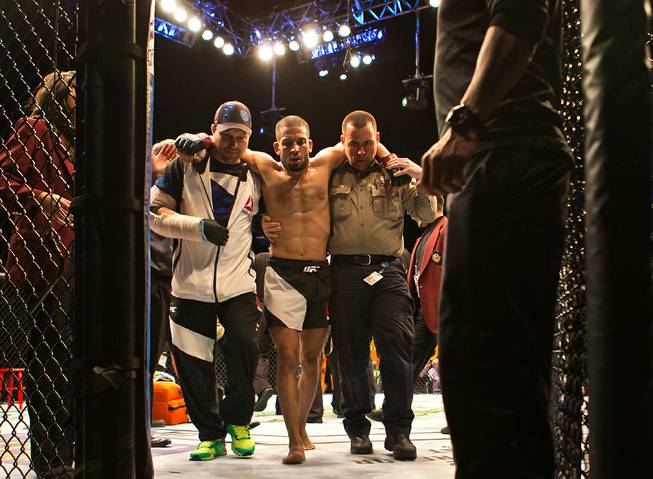 Featherweight Noad Lahat is assisted from the octagon by medical personnel after being knocked out by Diego Rivas during UFC Fight Night 82 at the MGM Grand Garden Arena on Saturday, February 6 2016.