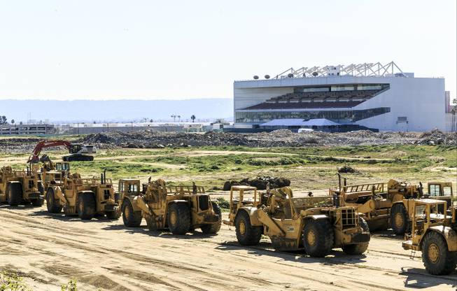 This Wednesday, Feb. 3, 2016, photo shows heavy machinery adjacent to the proposed NFL Rams stadium complex site at Hollywood Park in Inglewood, Calif. The largest contiguous block of unoccupied land in the Los Angeles area will be the site of Rams owner Stan Kroenke’s lavish stadium and a massive surrounding complex. In the background is the former Hollywood Park. 