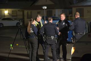 North Las Vegas Police officers and crime scene analysts confer after a fatal hit and run accident at the 3400 block of Thomas Avenue in North Las Vegas Sunday, Feb. 7, 2016. A two-year-old girl was killed in the accident.