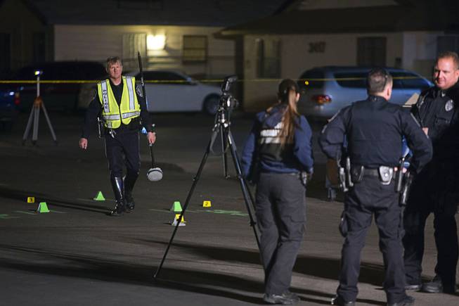 North Las Vegas Police officers and crime scene analysts investigate a fatal hit and run accident at the 3400 block of Thomas Avenue in North Las Vegas Sunday, Feb. 7, 2016. A two-year-old girl was killed in the accident.