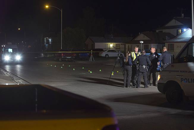 North Las Vegas Police officers and crime scene analysts confer after a fatal hit and run accident at the 3400 block of Thomas Avenue in North Las Vegas Sunday, Feb. 7, 2016. A two-year-old girl was killed in the accident.
