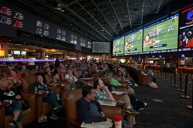 Football fans watch Super Bowl 50 in the Westgate Super Book Sunday, Feb. 7, 2016.