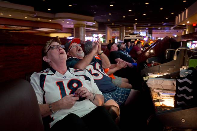 Denver Broncos fans Beverly and Bill Johnson of Norwalk, Calif., watch Super Bowl 50 on Sunday, Feb. 7, 2016, at the Westgate Super Book.