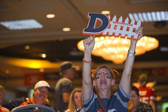 Kathy Harms of Greeley, Colo. cheers on the Denver Broncos as she watches Super Bowl 50 at the Westgate's Pigskin Party Sunday, Feb. 7, 2016.