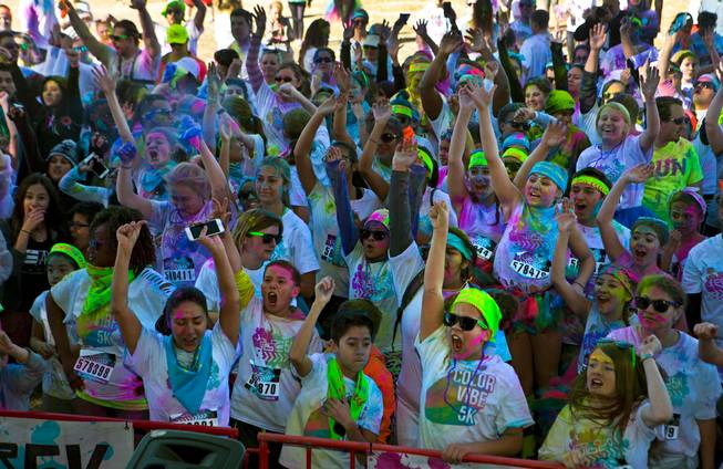 Runners are pumped and covered in dust about the stage following the Las Vegas Color Vibe 5K run at Craig Ranch Park on Saturday, February 6 2016.  A portion of the proceeds from the event will benefit the Nevada Childhood Cancer Foundation.  L.E. Baskow