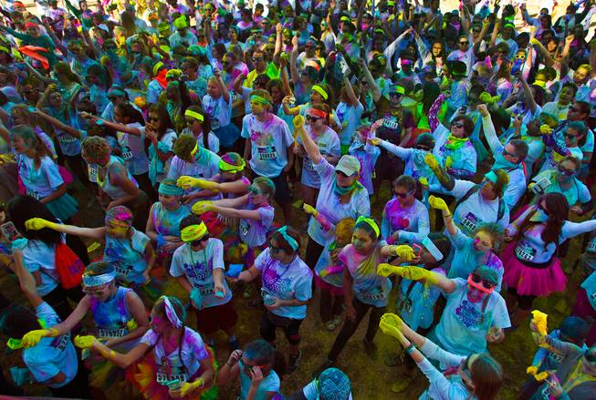 Runners ready to toss more colored dust in the air about the stage following the Las Vegas Color Vibe 5K run at Craig Ranch Park on Saturday, February 6 2016.  A portion of the proceeds from the event will benefit the Nevada Childhood Cancer Foundation.  L.E. Baskow