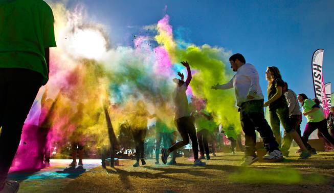 Runners are blasted with more dust as they reach the finish line of the Las Vegas Color Vibe 5K run at Craig Ranch Park on Saturday, February 6 2016.  A portion of the proceeds from the event will benefit the Nevada Childhood Cancer Foundation.  L.E. Baskow