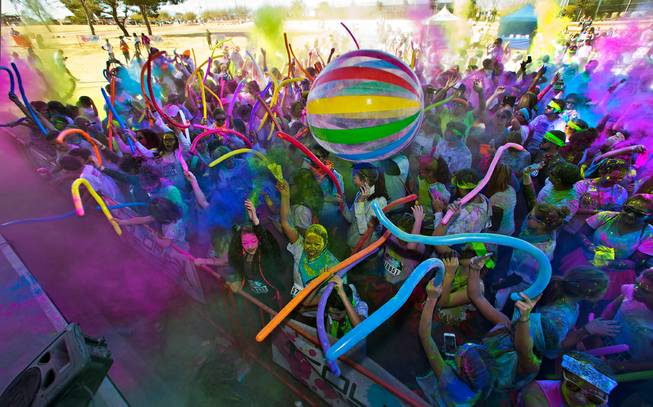 Runners toss colored dust in the air and celebrate about the stage following the Las Vegas Color Vibe 5K run at Craig Ranch Park on Saturday, February 6 2016.  A portion of the proceeds from the event will benefit the Nevada Childhood Cancer Foundation.  L.E. Baskow
