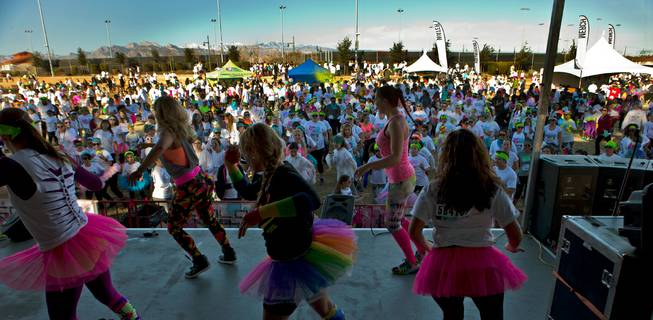 Runners gather about the stage for a warm-up dance prior to the start of the Las Vegas Color Vibe 5K run at Craig Ranch Park on Saturday, February 6 2016.  A portion of the proceeds from the event will benefit the Nevada Childhood Cancer Foundation.  L.E. Baskow
