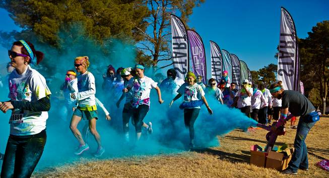 Runners are blasted with blue dust as they leave the start line of the Las Vegas Color Vibe 5K run at Craig Ranch Park on Saturday, February 6 2016.  A portion of the proceeds from the event will benefit the Nevada Childhood Cancer Foundation.  L.E. Baskow