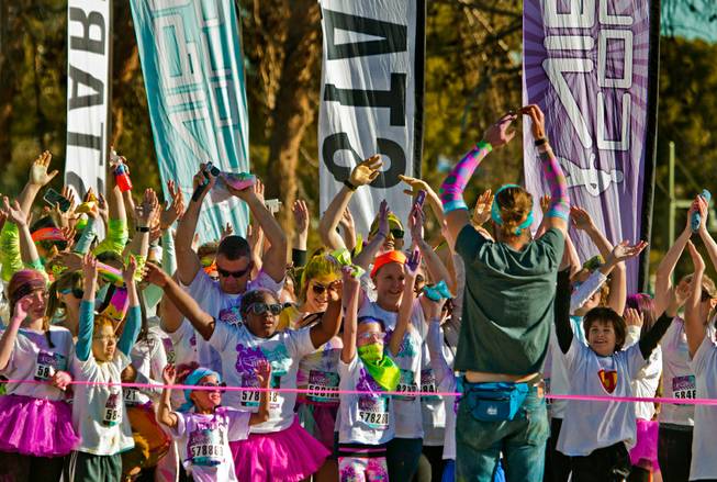 Runners get in a little stretch as they prepare to leave the start line of the Las Vegas Color Vibe 5K run at Craig Ranch Park on Saturday, February 6 2016.  A portion of the proceeds from the event will benefit the Nevada Childhood Cancer Foundation.  L.E. Baskow