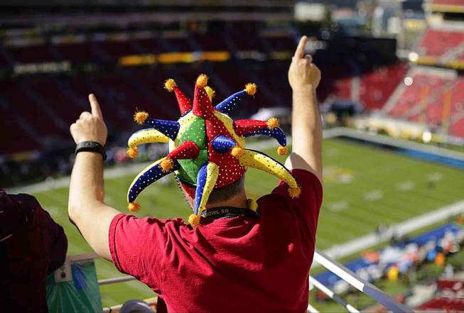 Larry Celano of Chandler, Ariz., watches warm ups before the NFL Super Bowl 50 football game between the Denver Broncos and the Carolina Panthers Sunday, Feb. 7, 2016, in Santa Clara, Calif. (AP Photo/Charlie Riedel)