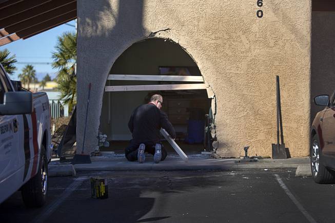 A workman boards up damage after a driver crashed into the waiting room of Lymphatic Therapy Services, 3560 South Jones Blvd., Monday, Feb. 8, 2016. Three people in the waiting room were injured, police said. 