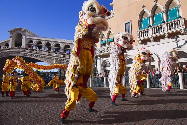 Lion and dragon dancers perform in front of the Venetian during Chinese New Year celebrations at the Venetian and Palazzo Monday, Feb. 8, 2016. The Chinese New Year, the Year of the Monkey, began Monday.