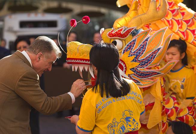 Rob Goldstein, president of Las Vegas Sands, paints the tongue of a dragon during Chinese New Year celebrations at the Venetian and Palazzo Monday, Feb. 8, 2016. The Chinese New Year, the Year of the Monkey, began Monday.