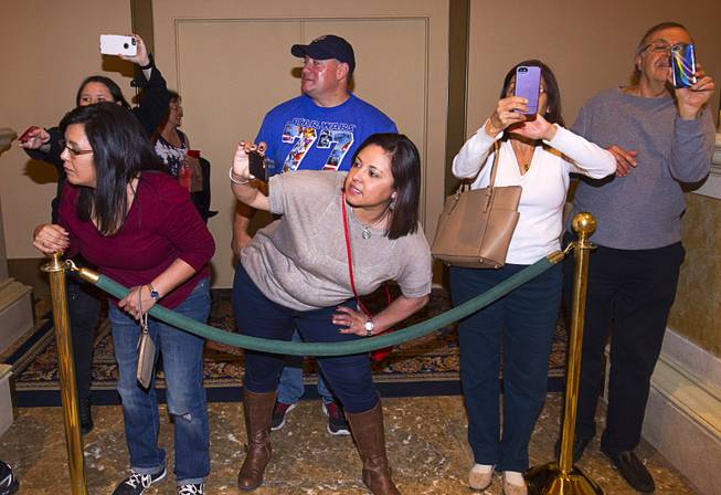 People take photos and video on their phones during Chinese New Year celebrations at the Venetian Monday, Feb. 8, 2016. The Chinese New Year, the Year of the Monkey, began Monday.