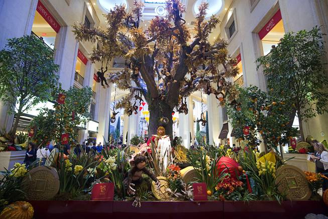 A 38-foot-tall wishing tree with 8,000 branches of golden foliage is displayed in the Waterfall Atrium and Gardens of The Palazzo Monday, Feb. 8, 2016. The Chinese New Year, the Year of the Monkey, began Monday.