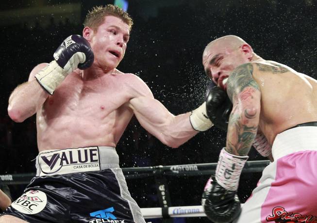 Canelo Alvarez,left, of Mexico connects on Miguel Cotto of Puerto Rico during their middleweight fight at the Mandalay Bay Events Center Saturday, Nov. 21, 2015.