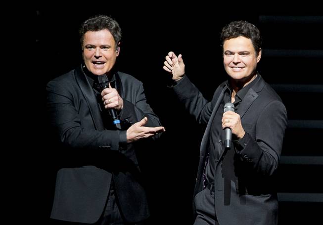 Donny Osmond, left, gestures to a Madame Tussauds wax figure of himself as Donny and Marie wax figures are unveiled during Donny & Marie show at the Flamingo Tuesday, Feb. 9, 2016. The figures will be permanently on display inside Madame Tussauds Las Vegas located in the Venetian.