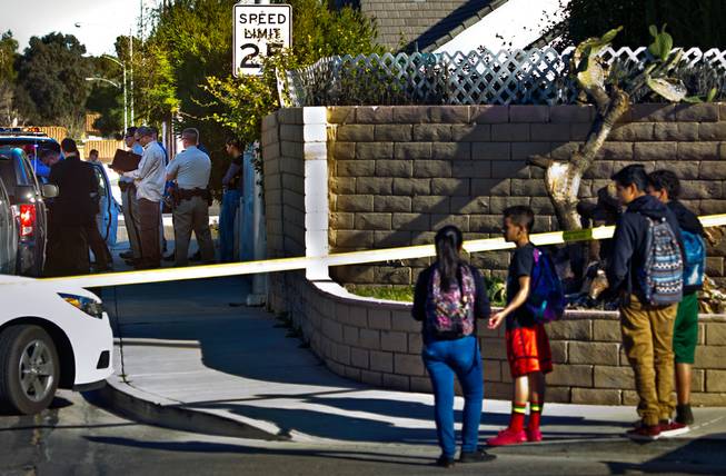 Metro Police respond to a homicide along S. Kennewick Drive as neighborhood kids walk home from school and stop to check things out on Tuesday, February 9, 2016.