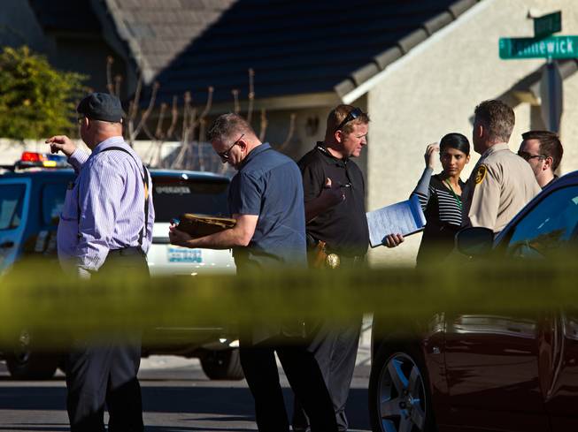 Metro Police gather to cover a homicide along S. Kennewick Drive on Tuesday, February 9, 2016.