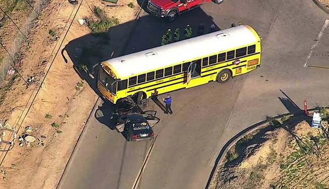 This still frame from videoprovided by KABC-TV shows the site of a collision between a car and a school bus in the southwestern Riverside County town of Menifee, Calif., Wednesday, Feb. 10, 2016, injuring at least 22 people. Authorities say one person in the car had major injuries, and another had minor injuries. 