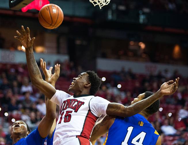 UNLV forward Dwayne Morgan (15) fights for control of the ball with San Jose State forward Frank Rogers (14) and others Wednesday, Feb. 10, 2016, at the Thomas & Mack Center.