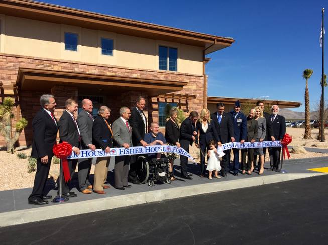 Nevada officials, including Gov. Brian Sandoval and North Las Vegas Mayor John Lee, participate in a ribbon-cutting ceremony Thursday, Feb. 11, 2016, at the Fisher House. The 13,500-square-foot home will provide temporary housing for family of military members and veterans receiving treatment locally. It's located in North Las Vegas next to the VA Southern Nevada Healthcare System.

