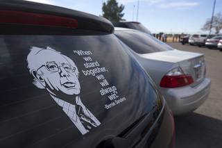 A quote by Democratic presidential candidate Bernie Sanders adorns the rear window of a  car as people line up to attend a Sanders rally at Bonanza High School Sunday, Feb. 14, 2016.