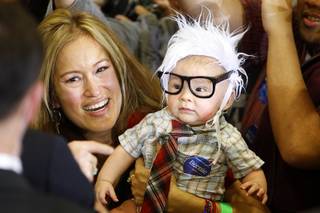 Oliver Lomas, 3-months, wears a Bernie Sanders outfit as Democratic presidential candidate Sen. Bernie Sanders (VT) greets supporters during a rally at Bonanza High School Sunday, Feb. 14, 2016. Nevada Democratic caucuses are Saturday, Feb. 20.